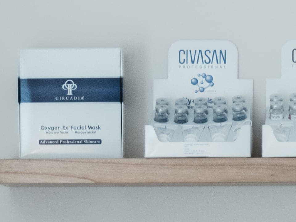 A Circadia Oxygen Rx Facial Mask box on the studio shelf, beside a Civasan Professional ampoule display