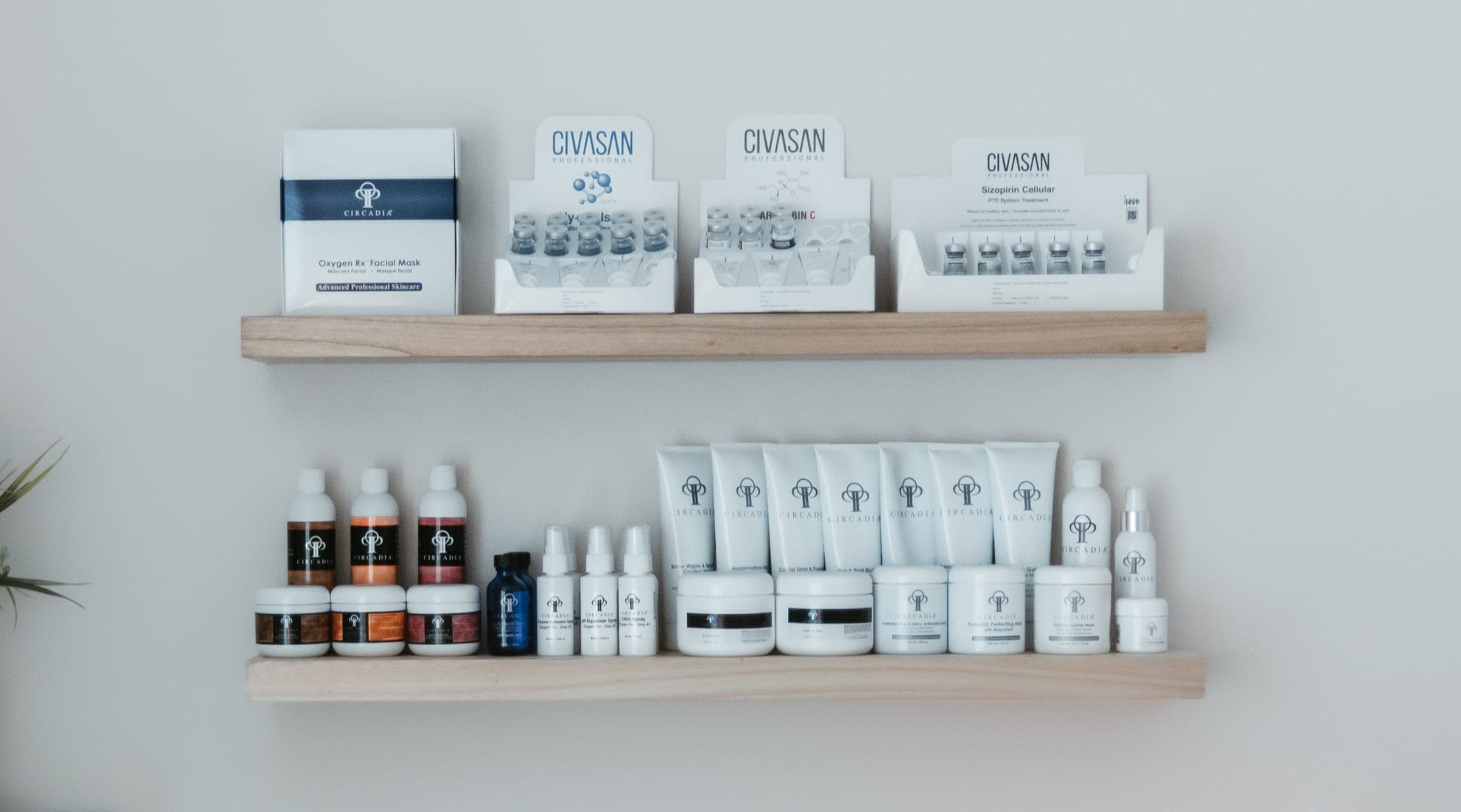Two oak shelves in the Nourish Skin Nashville studio holding Circadia and Civasan Professional skincare